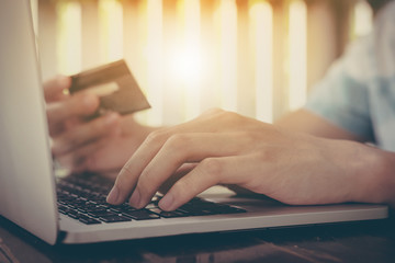 Online payment, Man's hands holding a credit card and using smartphone and choose some product what him want for online shopping.