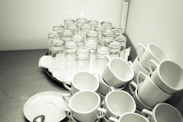 Cups and glasses on a restaurant kitchen. Selective focus. Shallow depth of field. Toned
