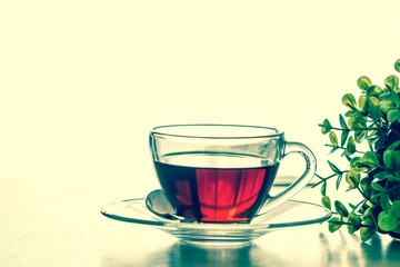 Close up the warm black tea cup on the wooden table in living room , relax with tea time concept