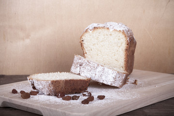 Slices of curd cake with sugar powder on the wooden cutting board. Selective focus. Toned