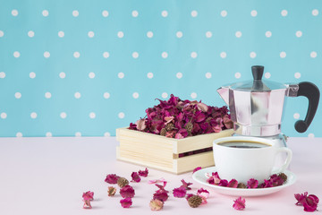 Hot black coffee and coffee maker with dried flower orchid in crate copy space.