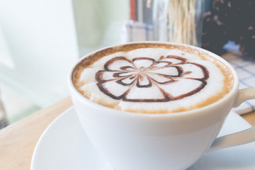 hot coffee with foam milk art in afternoon break