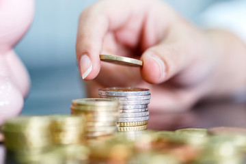 Female hand stack euro coins to shown concept of growing business and wealthy. Saving money concept