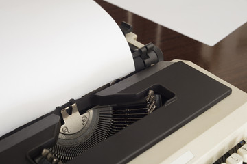 Close up of typewriter and white sheet