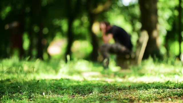 Depressive man on park bench, out of focus to be unrecognizable