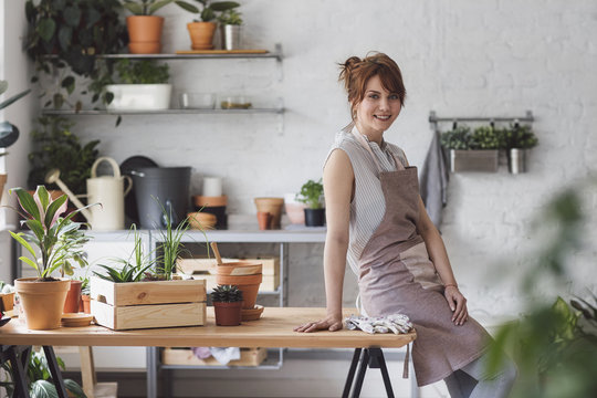 Portrait of beautiful Caucasian woman florist looking at camera and smiling.
