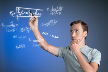 Man scientist or student working with various high school maths and science formulas.