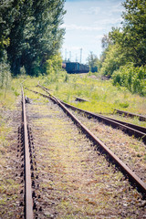 Railway junction in the spring. Green trees and flowers.