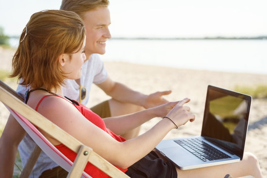 Young couple discussing something on a laptop