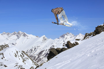Naklejka na ściany i meble Flying skier in the mountains. Extreme freeride sport.