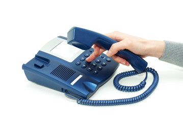 hand holding phone receiver and dialing number