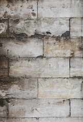 Wall of gray travertine adarce stone bricks