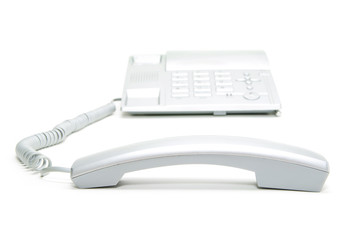 hand holding phone receiver and dialing number