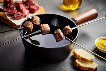 Cooking tender beef in a fondue pot