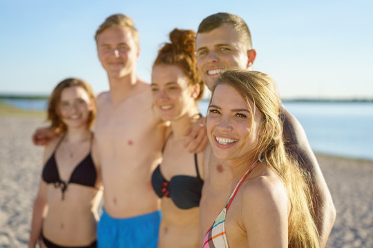 Group of young people in a line on the beach