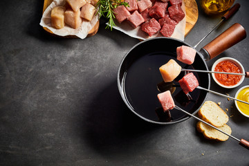 Mixed meat fondue with seasoning and dips