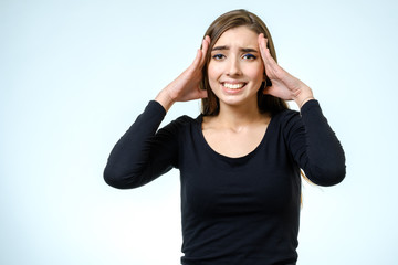 Young pretty brunette girl touching her head