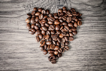 Coffee beans concept on wooden table background.