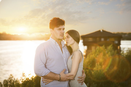 two lovers embrassing on sunset
