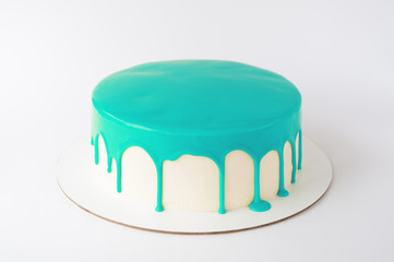 Cake baking with cyan glaze on white background. Picture for a menu or a confectionery catalog.