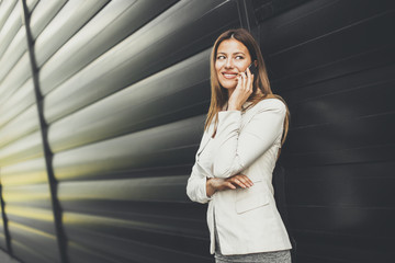 Fototapeta premium Pretty businesswoman using smart phone