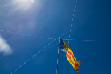 Obraz premium Catalonia flag in Valencia, Spain on the blue sky background