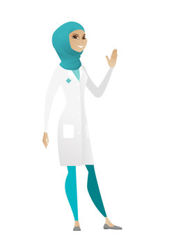 Young muslim doctor waving her hand.
