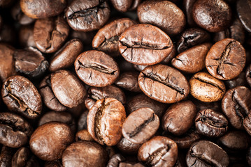 Naklejka premium Coffee beans concept on wooden table background.