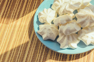 Zephyr and  marshmallows  on a blue plate