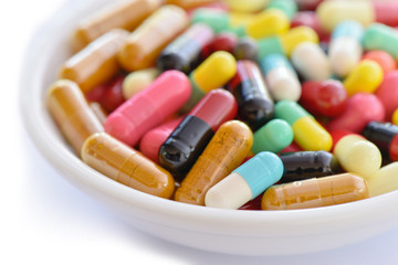 Close-up multicolor pill capsule in container