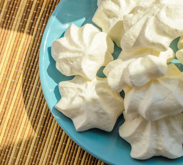 Zephyr and  marshmallows  on a blue plate