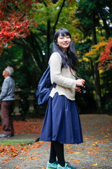 japanese young woman in autumn leaves