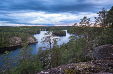 Scenic landscape with lake and storm clouds at summer evening in Repovesi, National Park. Finland