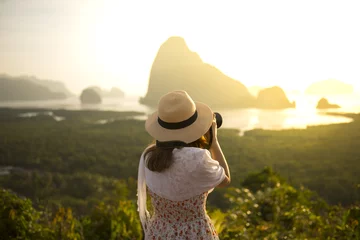  Woman tourist is taking photograph at Samed Nang She point of view in Phang Nga, Thailand during summer time.  © newroadboy