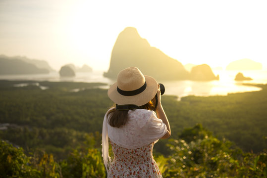 Woman tourist is taking photograph at Samed Nang She point of view in Phang Nga, Thailand during summer time. 