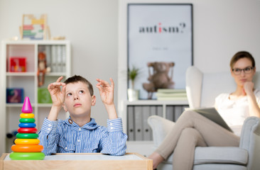 Psychologist observing autistic boy