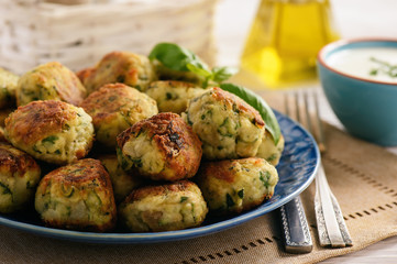 Fried crispy zucchini balls with feta cheese- vegetarian food.