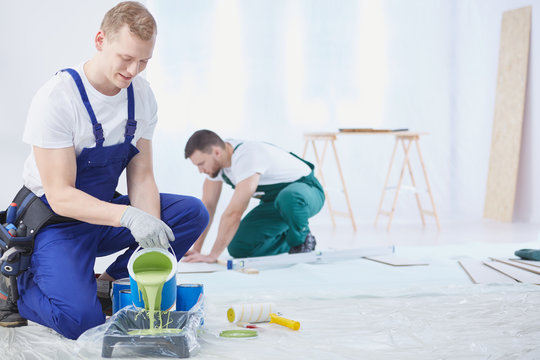 Renovation crew  mixing the paint