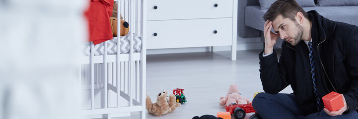 Tired man on room floor