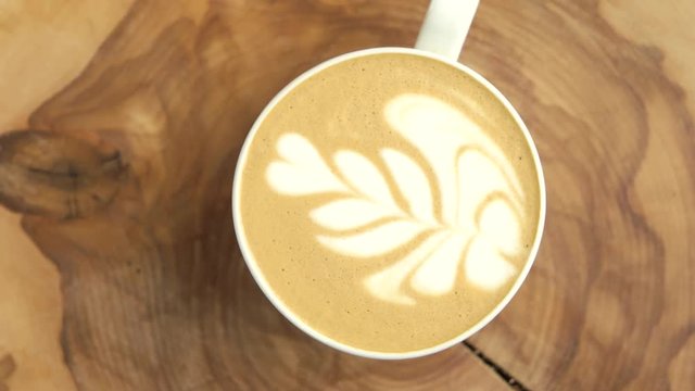 Latte cup top view. Coffee foam art flower.