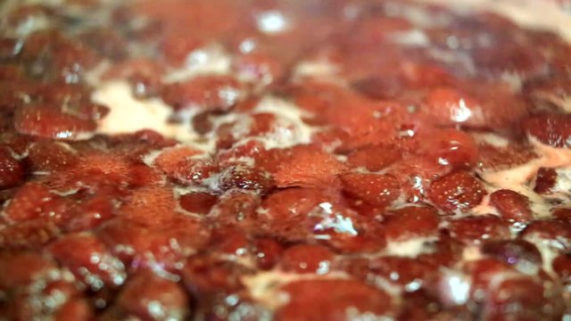 Cooking delicious strawberry jam closeup