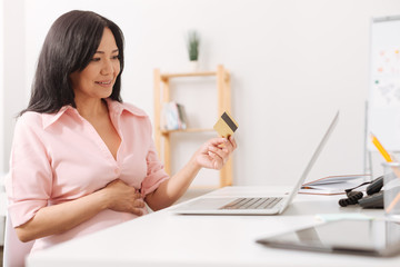 Fototapeta premium Nice pregnant woman holding her credit card