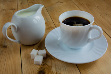 Coffee with milk on a wood table