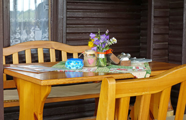 Table in Slovak restaurants, chairs and decoration, wooden house