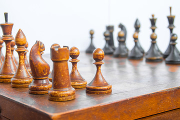 Old chess Board with wooden pieces.