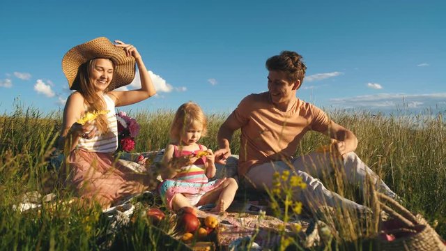 happy family eating pineapple at a picnic
