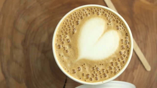 Latte art heart. Coffee cup and lid.