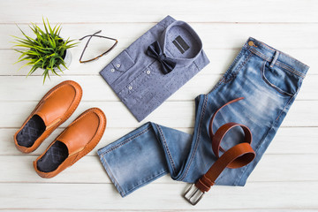 Fashionable concept, men's clothes with accessories items on white wooden board background 