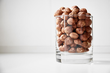 Glass of nuts. White background.
