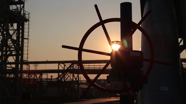 Pipe and valve at sunset